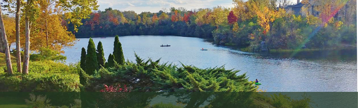 Aerial view of Hidden Lake with fall foliage and kayakers on the water